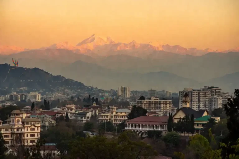 Dehradun news city skyline with snow-capped Himalayan mountains in background
