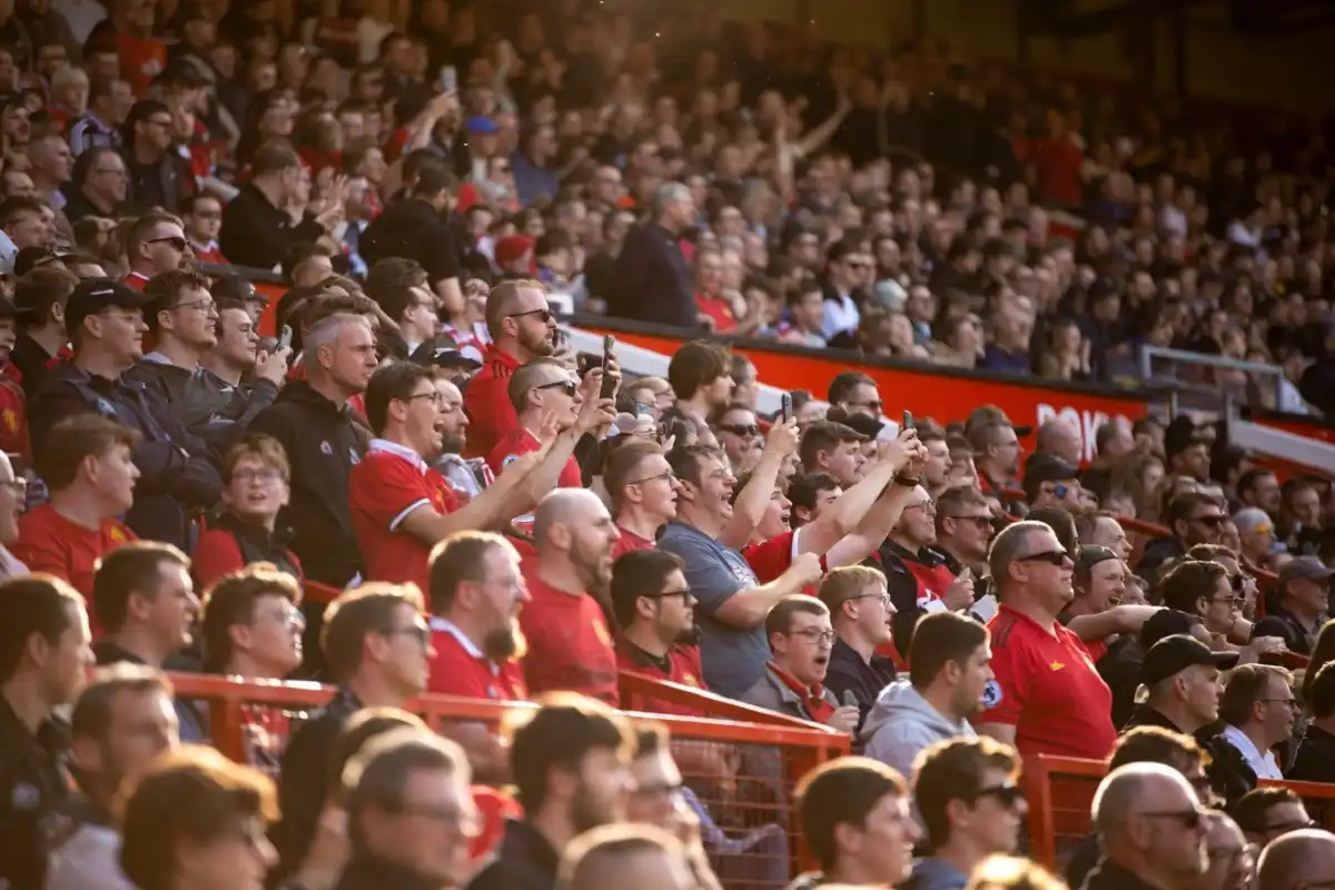 Manchester United fans reacting to transfer news at Old Trafford