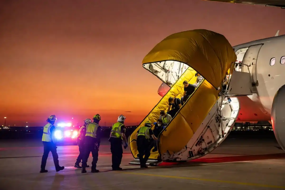 Emergency rescue operation following plane crash news — survivors being assisted at crash site