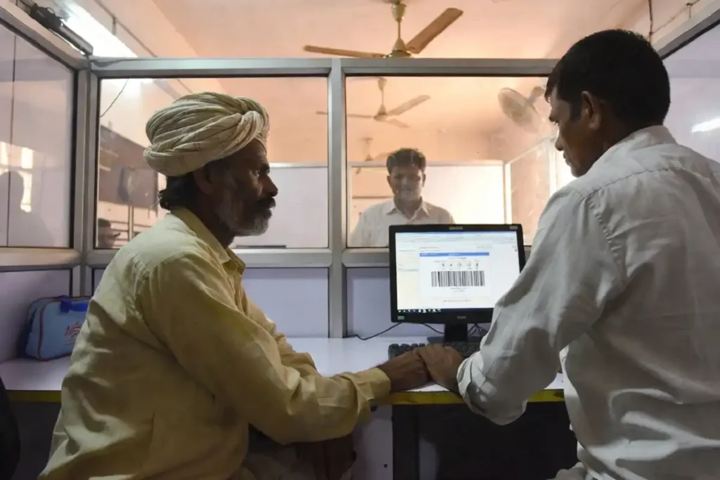 Farmer completing PM Kisan e-KYC verification at a Common Service Centre with official